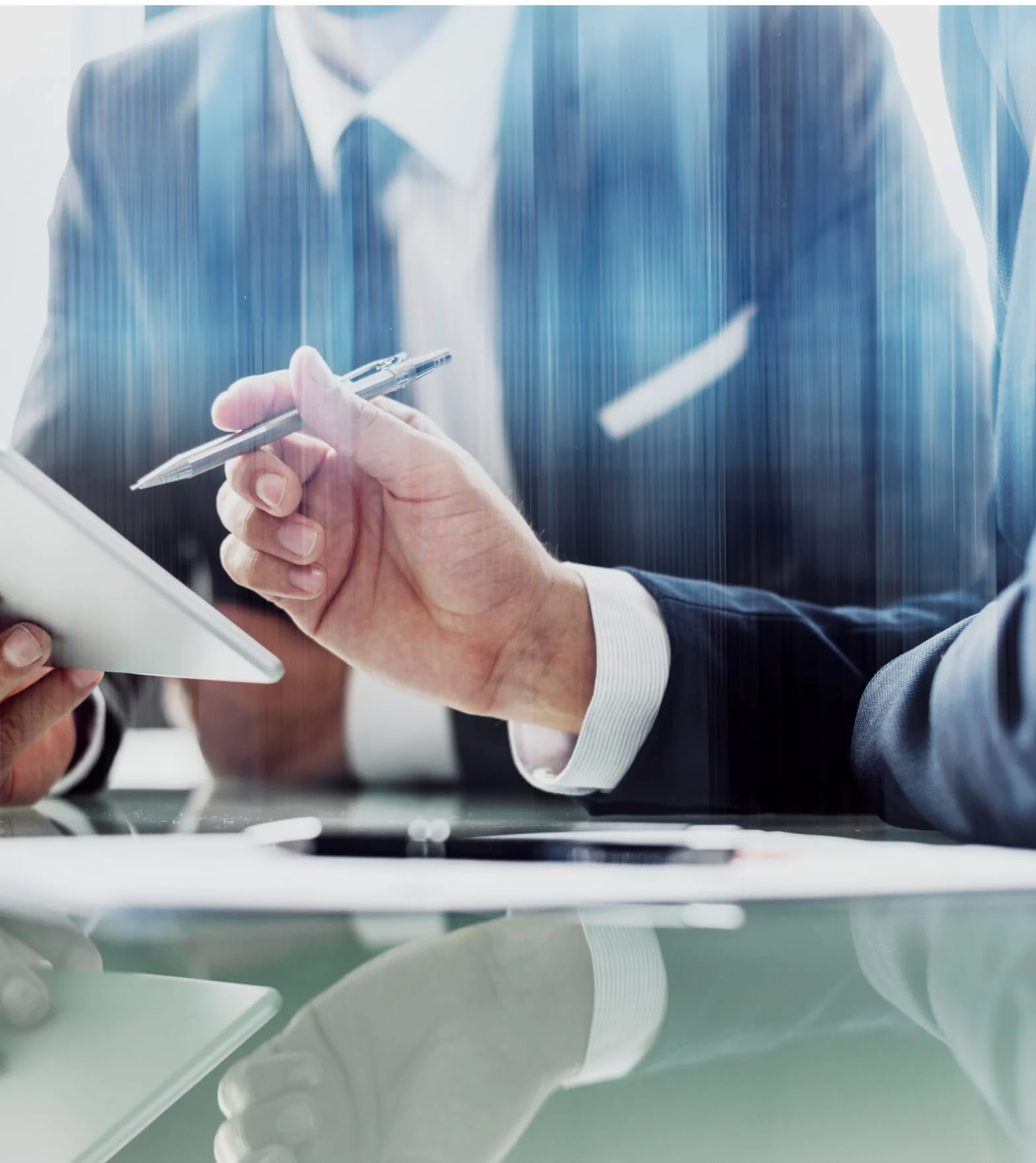 Businessman writing on a document, city reflections behind