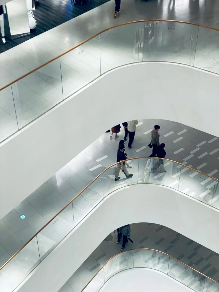 Curved white staircases of a modern building atrium viewed from above