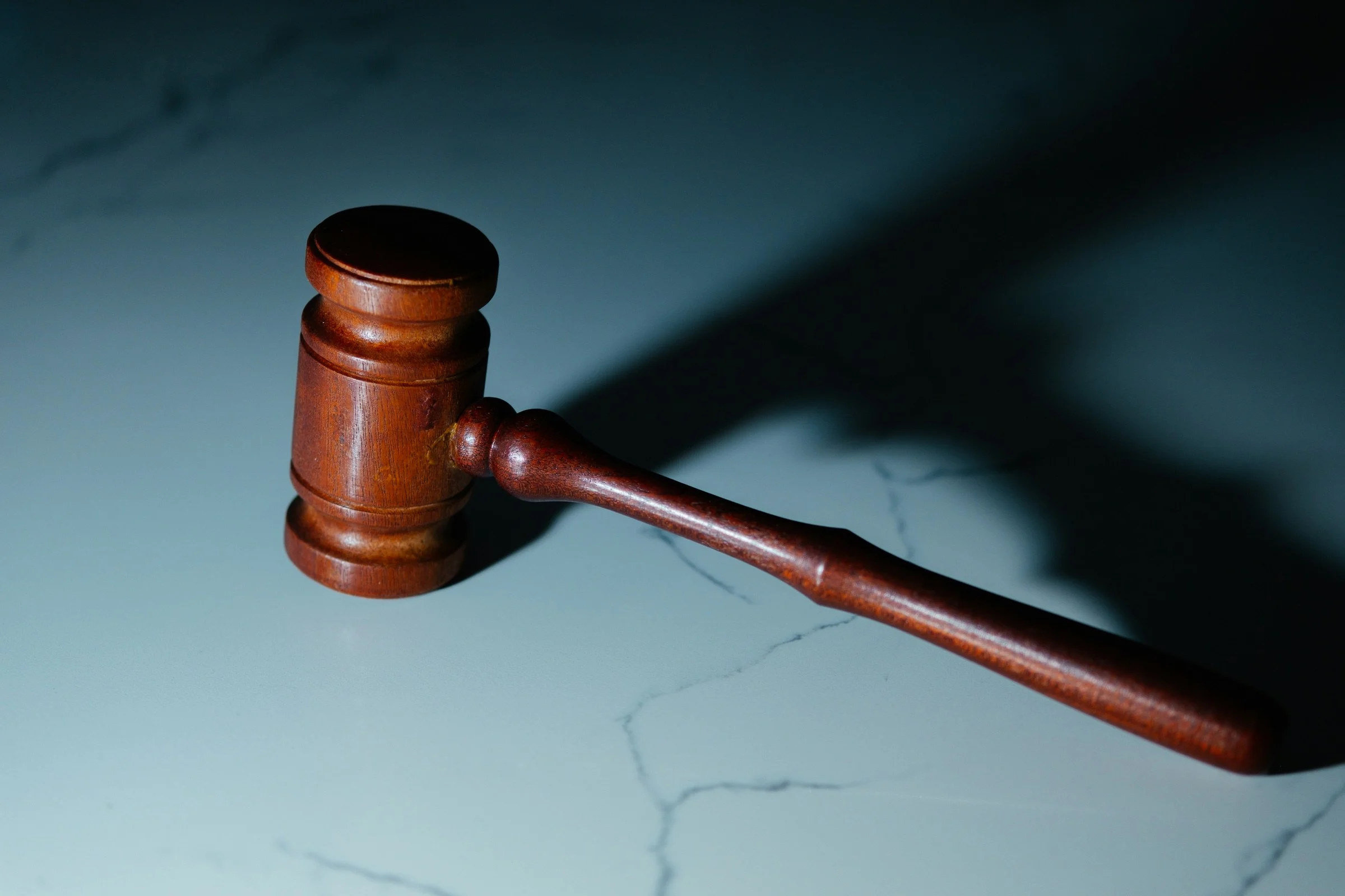 Wooden judge's gavel on a marble surface